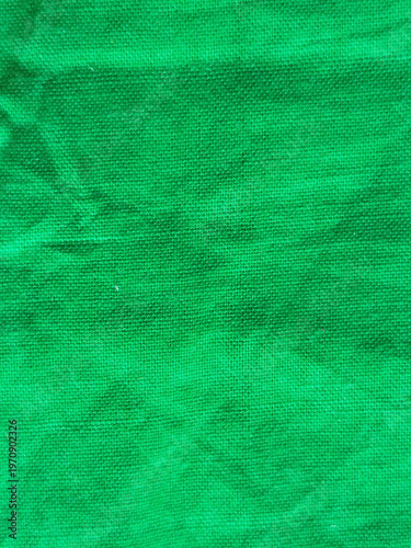 Textura de tela de algodón de color verde vibrante con superficie arrugada