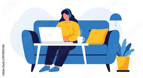 Young woman working from home while sitting comfortably on a blue sofa with a laptop headphones and a cup of coffee.