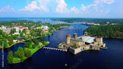 Aerial view of Olavinlinna Medieval Castle in Savonlinna. Exploring a Picturesque Castle Surrounded by Lush Forests and Serene Waters in a Tranquil Landscape