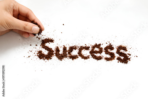 Coffee grounds form the word Success.