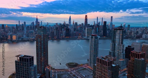 View on East Side Manhattan from Malt Drive in Queens. Drone footage over the waterfront at dusk time. New York, USA.