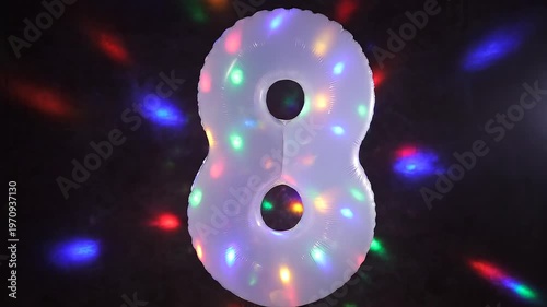 White number 8 balloon with colorful flashing disco lights. Festive video for birthday or anniversary party