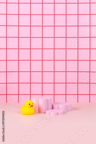 Sweet pink bathtub and yellow rubber duck in pink bathroom background
