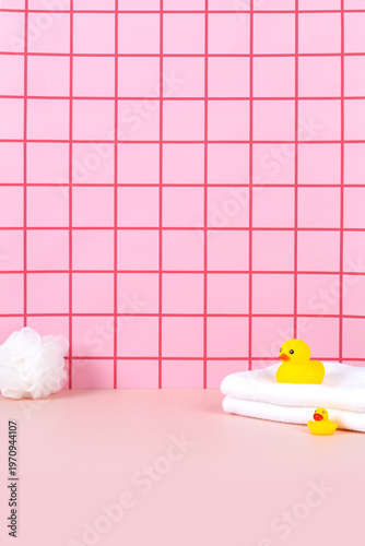 Sweet pink bathtub and yellow rubber duck in pink bathroom background