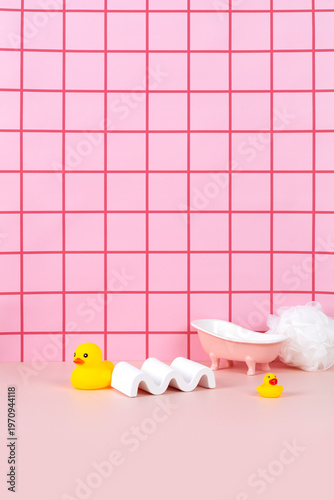 Sweet pink bathtub and yellow rubber duck in pink bathroom background