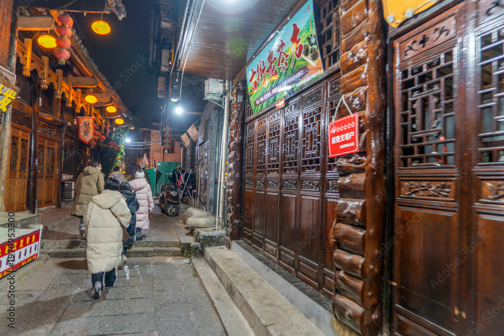 Obraz premium Furong Ancient Town is more than 2000 years old and home to the Tujia and Miao people, ethnic minorities in China, with lighting waterfall, The famous tourist destination at Hunan Province, China