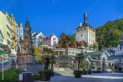 Market Colonnade and Castle Tower in Karlovy Vary, Czech Republic. Historical square architecture under clear blue sunny sky