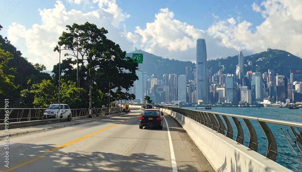 Fototapeta premium A scenic highway by the water with a city skyline