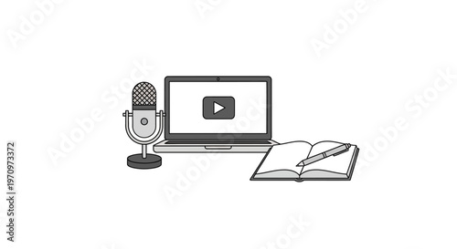 Laptop with microphone and open book.