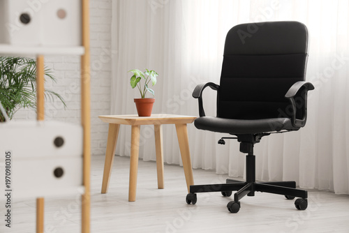 Black chair with table near...