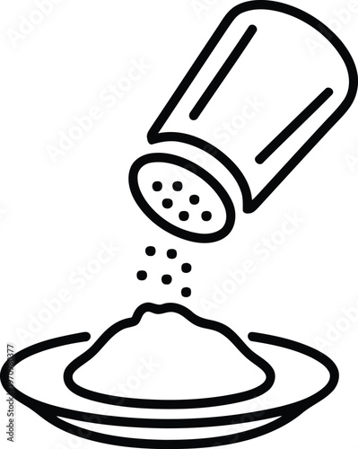 A salt shaker pouring salt onto a plate