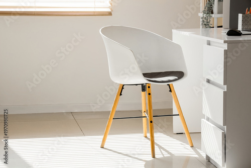 White chair near desk in li...