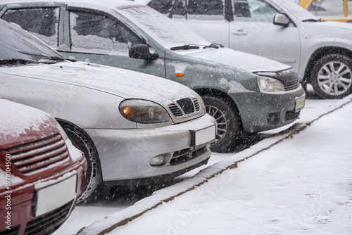 Modern cars covered with sn...