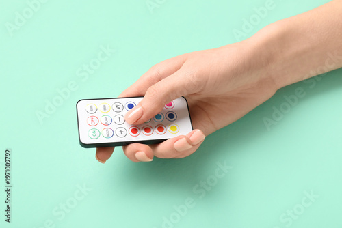 Female hand with remote con...