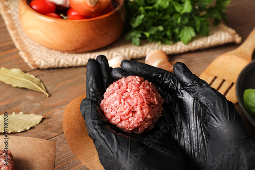 Woman holding fresh meatbal...