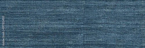 This image features a detailed texture of dusty blue silk fabric with a prominent horizontal grain. The woven material displays a subtle slub pattern, perfect for a textile background.