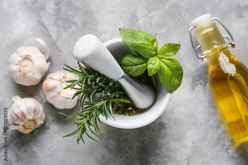 Mortar with basil leaves, r...