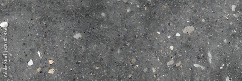 A dark gray terrazzo stone texture featuring a variety of mineral inclusions in white, light gray, and tan shades, creating a flamed and matte surface suitable for background use.