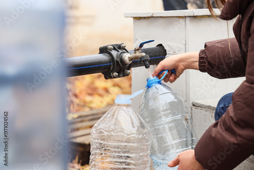 Woman filling plastic bottl...