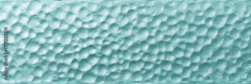 This pale aqua hammered glass texture tile displays a dimpled surface with a frosted finish. The decorative rectangular panel has a translucent blue-green color and a bumpy pattern.