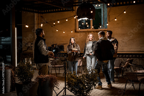 Cuadro en lienzo Group of friends filming a scene in an outdoor setting at night with creative li