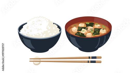 Traditional japanese meal consisting of a bowl of white rice, miso soup with tofu and seaweed, and a pair of bamboo chopsticks.