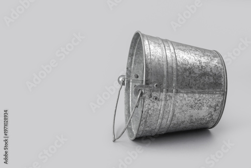 Metal bucket on grey backgr...