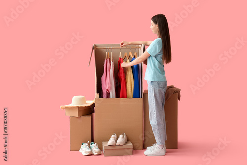 Young woman and wardrobe bo...