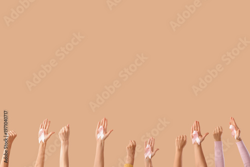 Many female hands with pink...