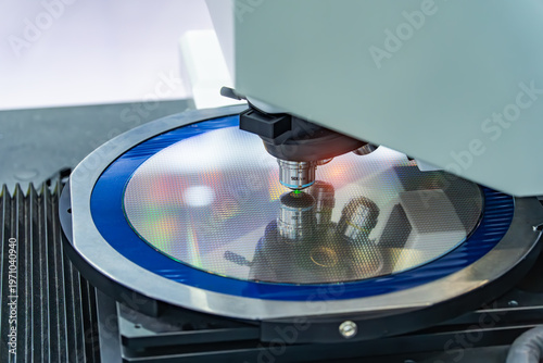 silicon wafer with microchips on machine process examining in microscope and checking quality,integrated circuits to manufacture CPU and GPU