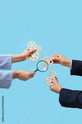 Hands with wooden gears and...