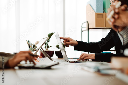 Brainstorming of young modern group. Team meeting to achieve goal. Business people discussing finance business and analysis. Teamwork concept in modern office. Calculating personal tax for client.