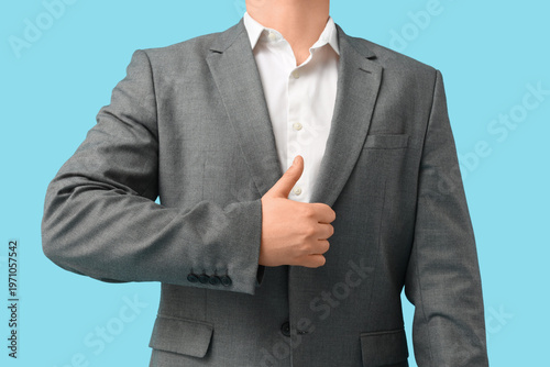 Businessman showing thumb-u...