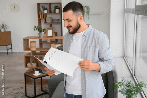 Young man with refund form ...