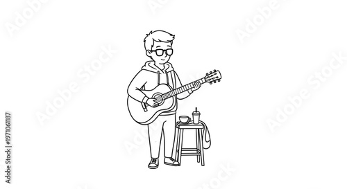 Young man with glasses playing acoustic guitar with a drink on a stool beside him, enjoying a casual musical moment