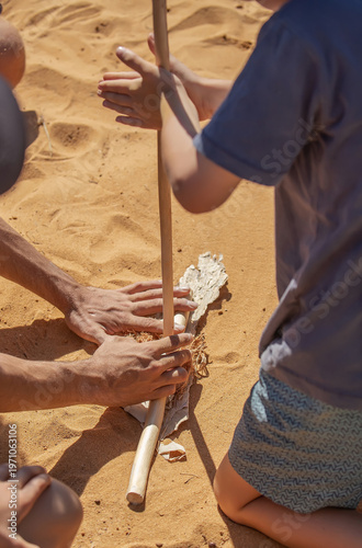 Traditional fire making by friction using wooden sticks in Australian indigenous survival practice