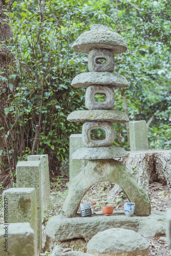 Photography Traditional Japanese Stone Lantern in Garden with Offering Cups