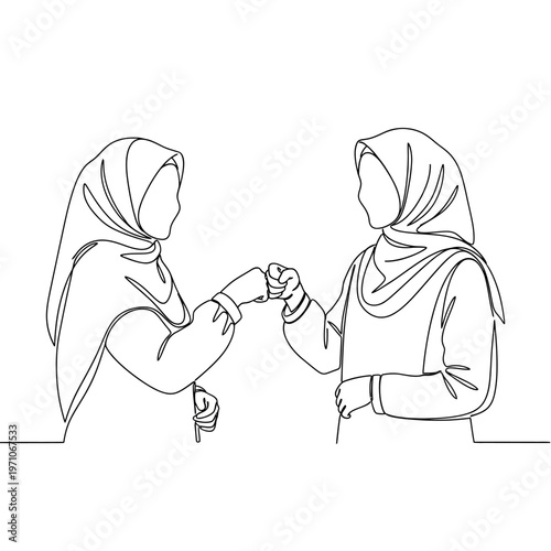 Two Women Wearing Headscarves Fist Bumping.