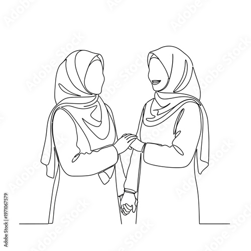 Two women wearing headscarves shaking hands.