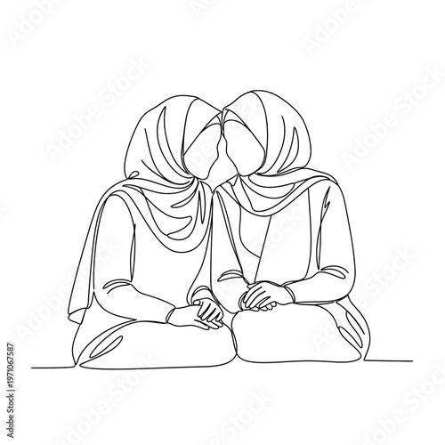 Two women wearing headscarves sitting together.