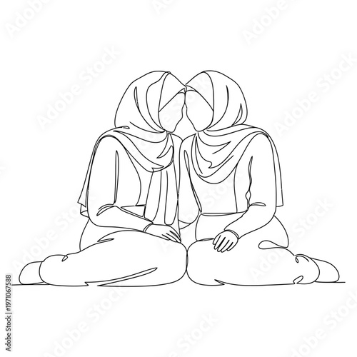 Two women wearing headscarves sitting together.