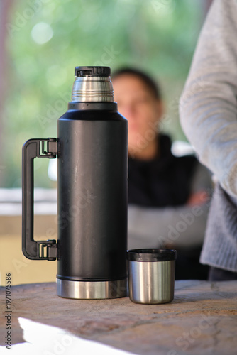 a black thermos on the table