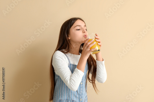 Little girl drinking orange...