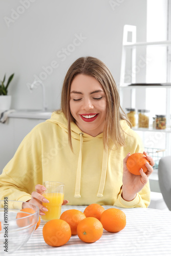 Young woman with glass of o...