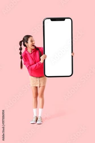 Happy young woman holding b...
