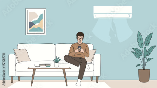 Young man relaxing on a white sofa while using his smartphone in a living room kept cool by a modern wall-mounted air conditioning unit.