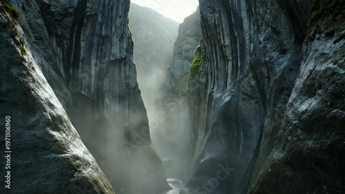 Misty canyon with rugged rock formations.