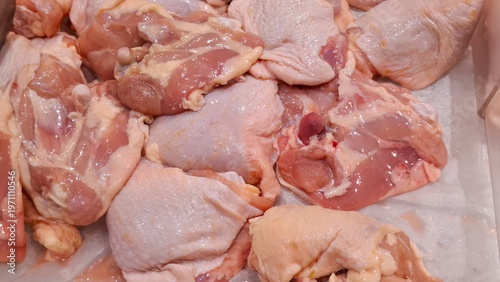 Tableau sur toile Fresh raw boneless chicken thighs meat on display for healthy protein meal prepa