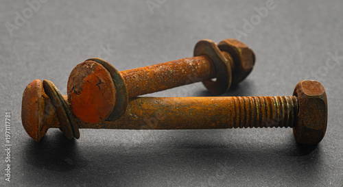 rusty construction bolts on a black background