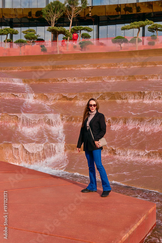 A young girl walks in the park in the summer